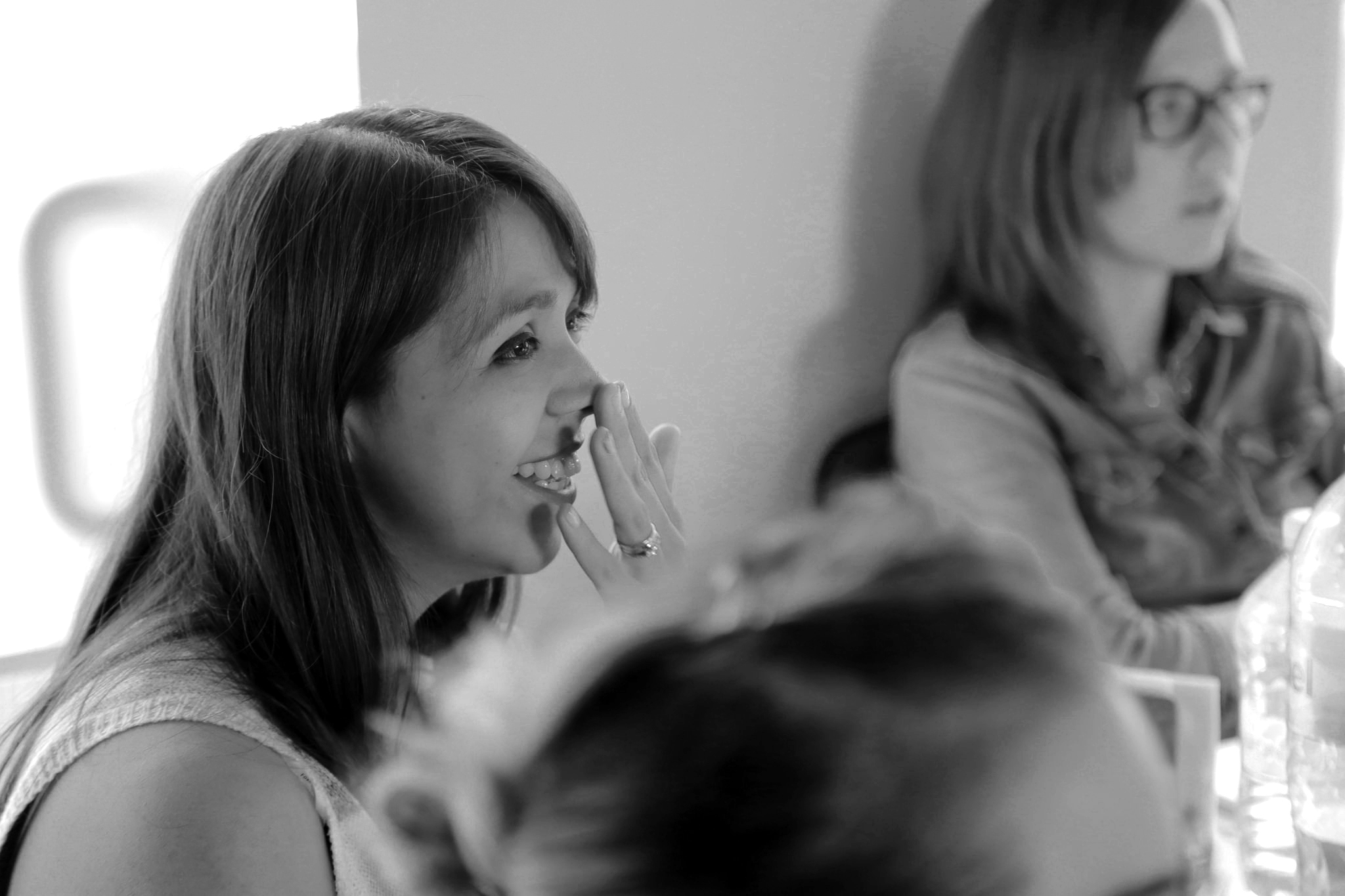 Woman laughing in business meeting