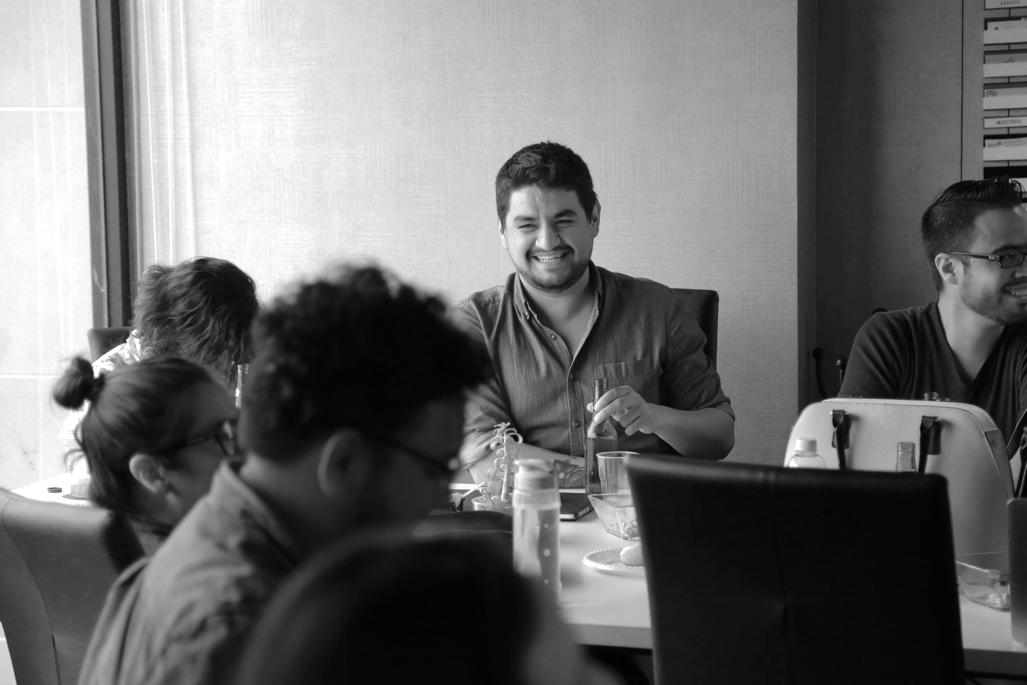Man laughing at business meeting
