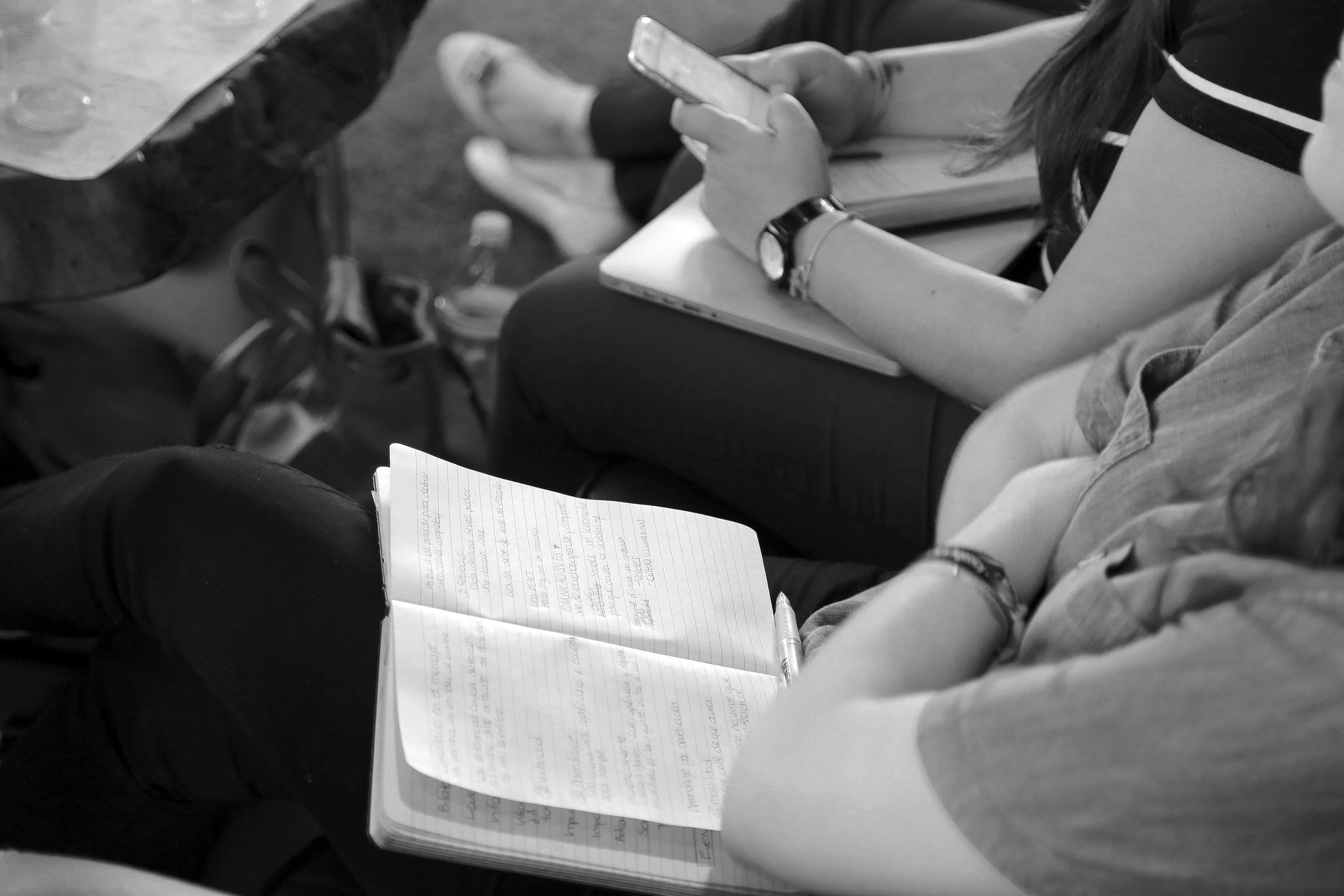 People taking notes and using phone