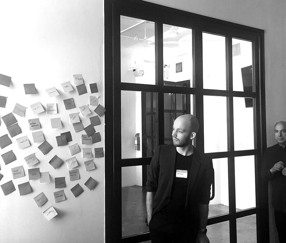 Man staring at wall full of post its