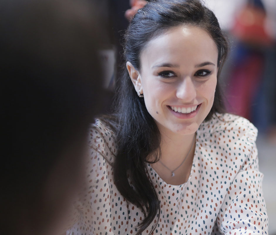 Woman smiling while conversing with friend