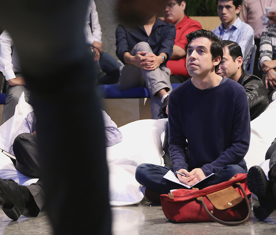 Man sitting on the floor listening to presentation