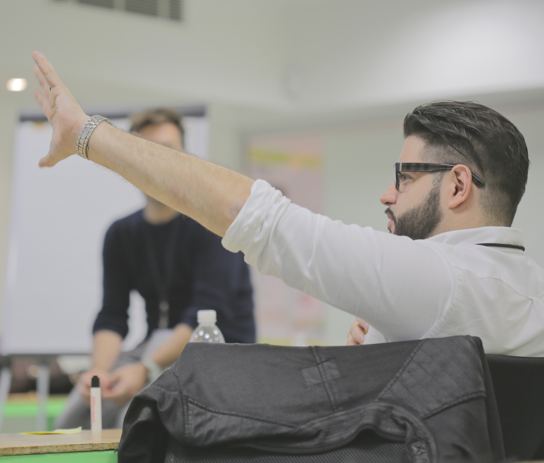 Men with glasses speaking in business meeting