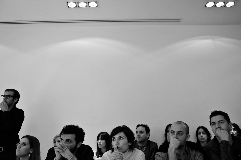 Crowd in small talk photographed in black & white