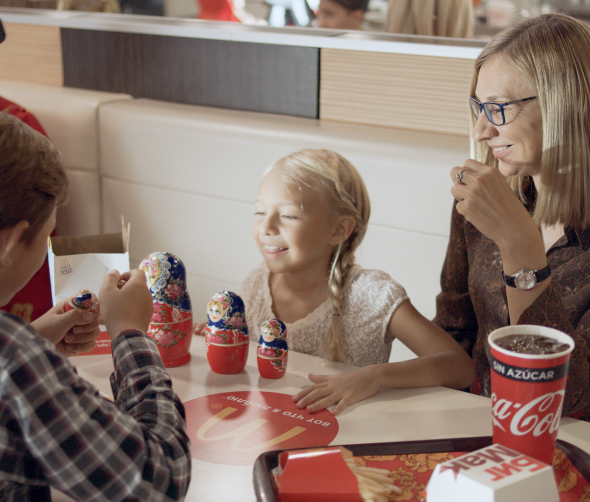 Family eating at mcdonalds and playing with matrioshkas