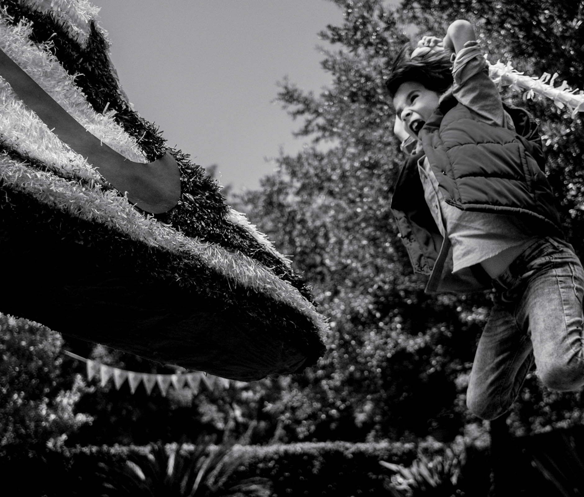 Kid hitting a nike shoe piñata