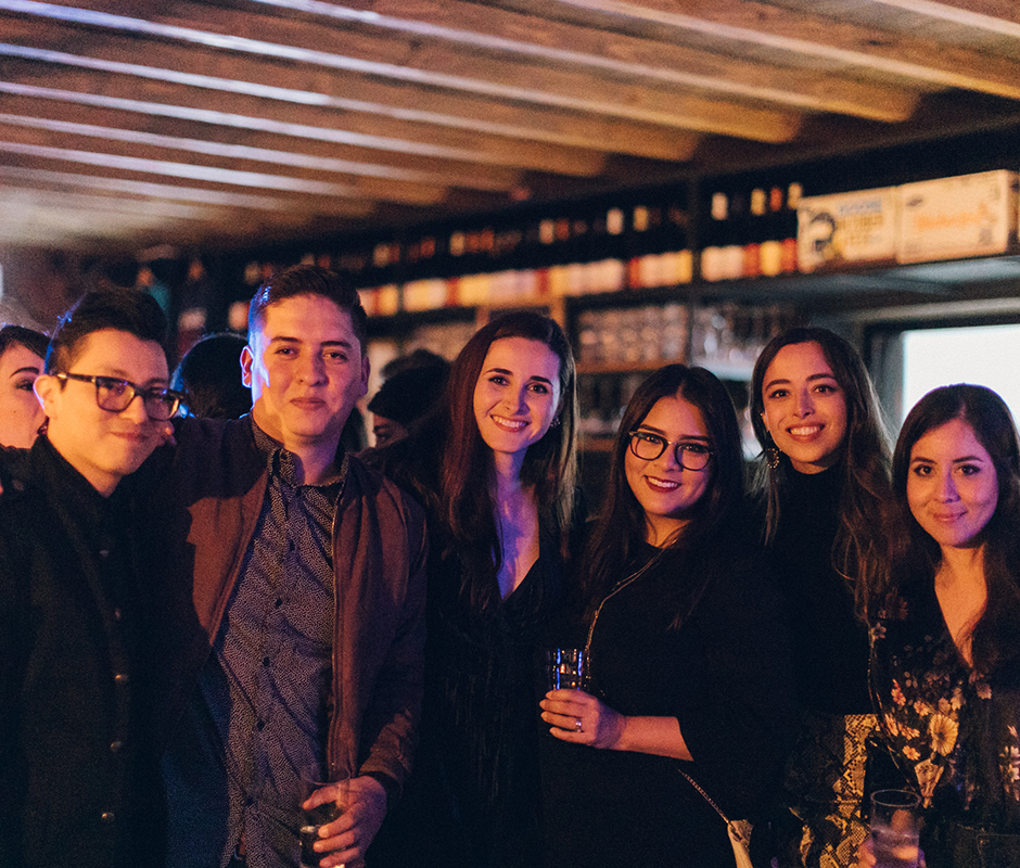 Friends photographed together at bar