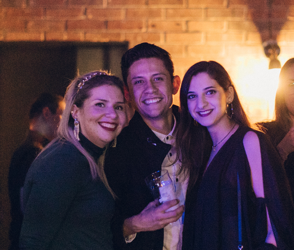 People posing for picture at bar