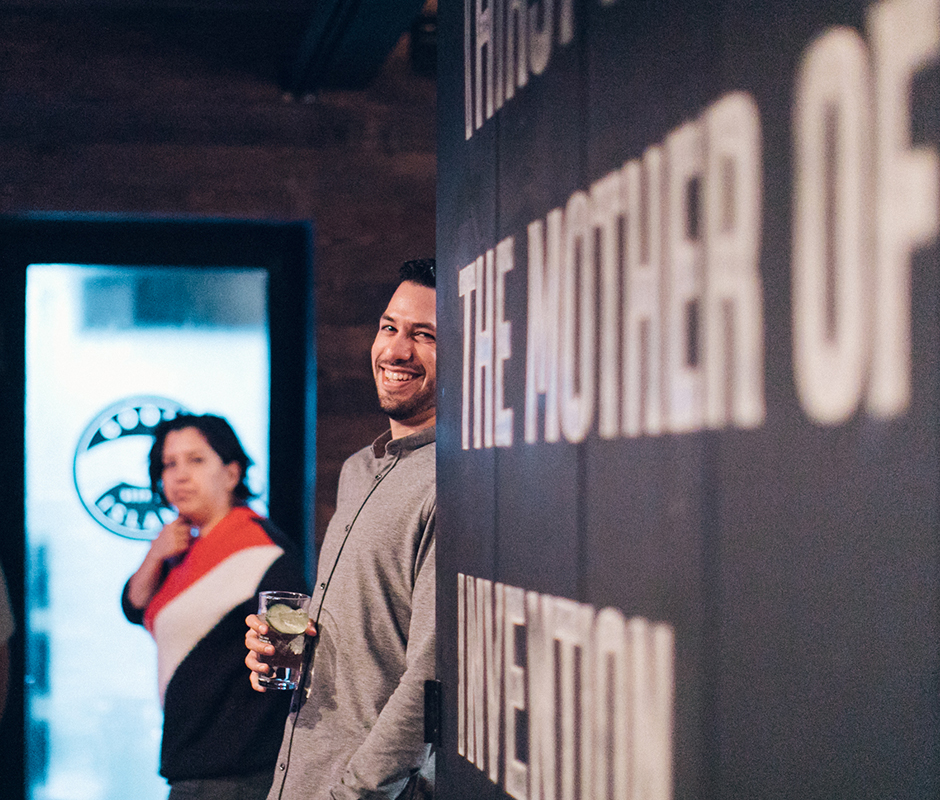 Man leaning on wall smiling