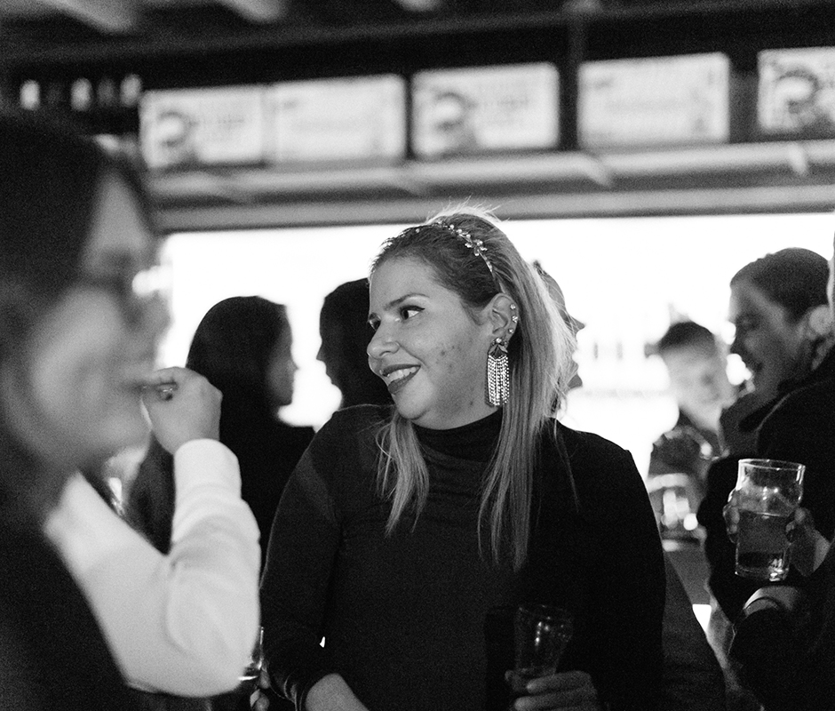 Woman in conversation with friends smiling