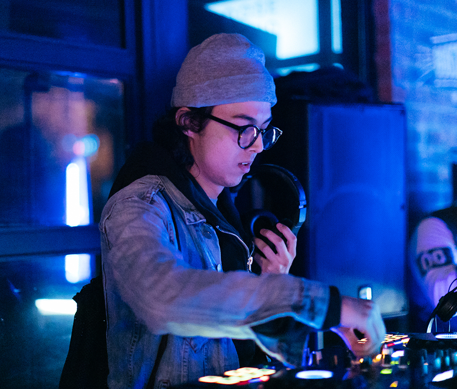 Man with glasses playing dj set