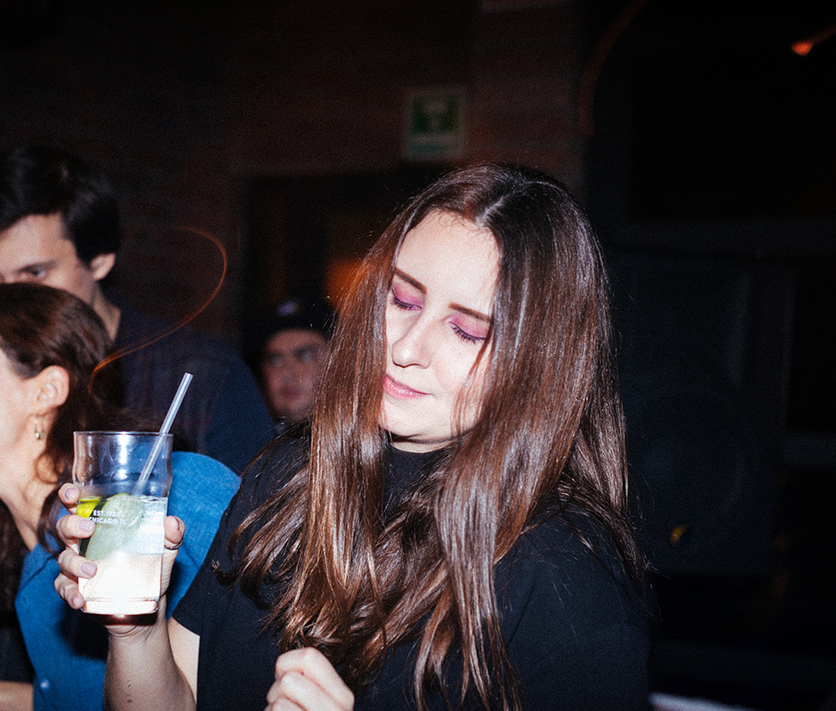 Woman with drink in hand vibing 