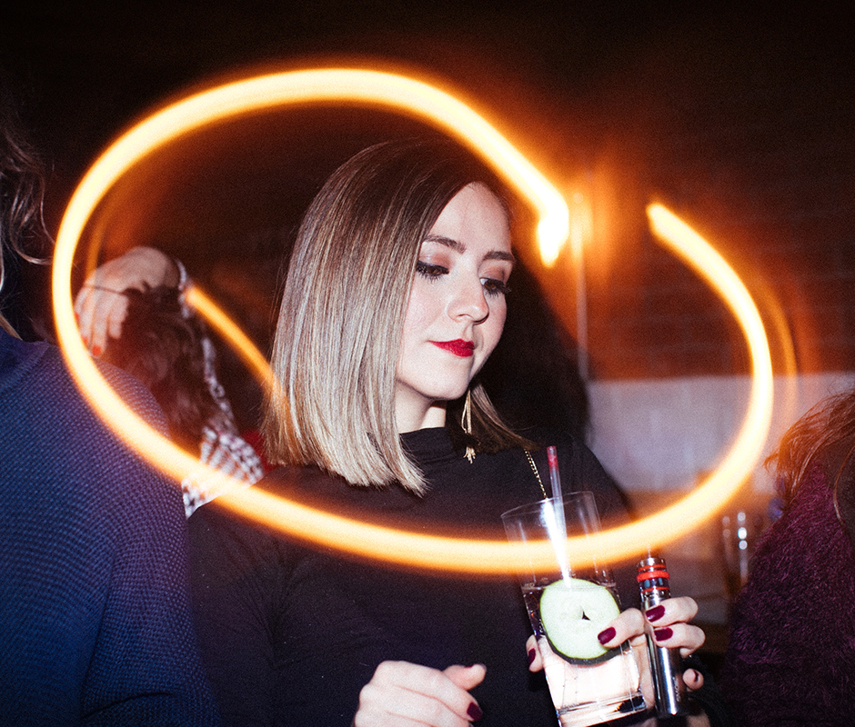Woman with drink and vape at christmas party
