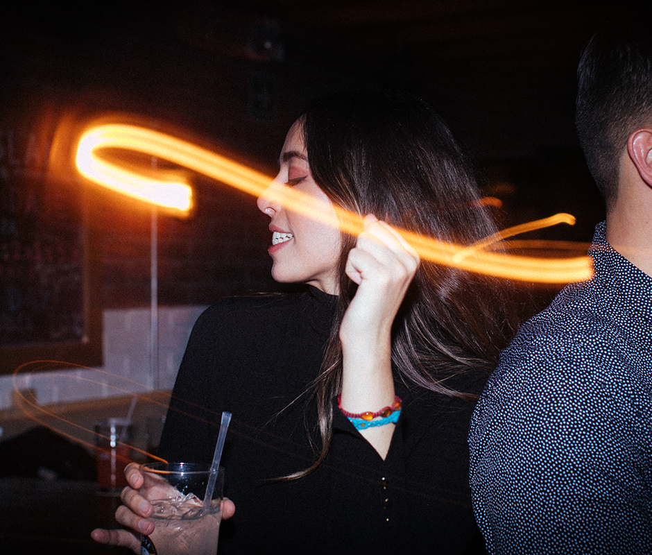 Woman photographed dancing with camera flare