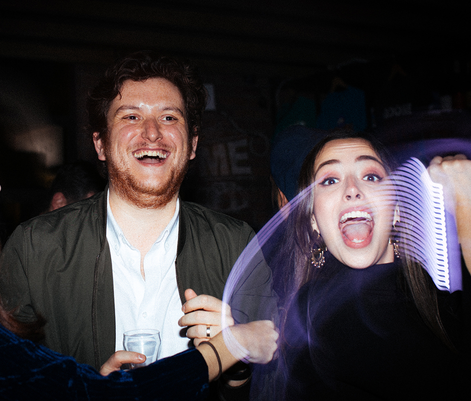 Friends photographed laughing with camera flare effect