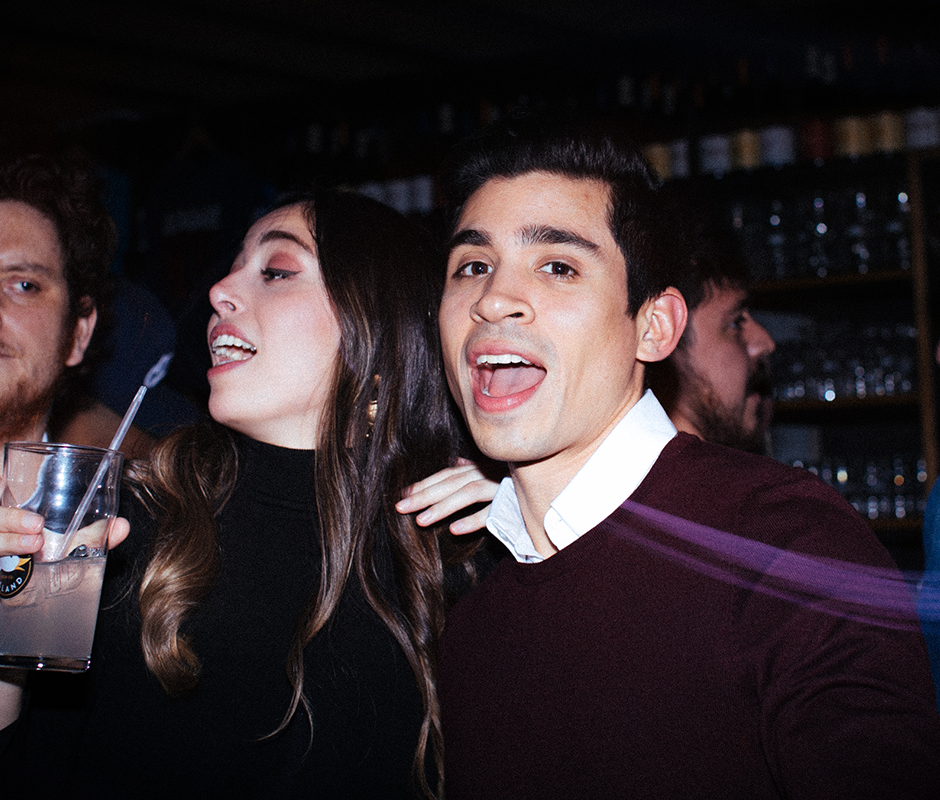 Friends singing along at bar party