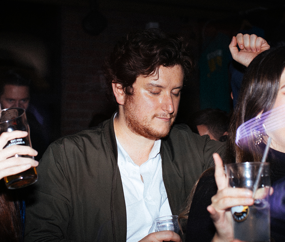 Men with eyes closed dancing at party