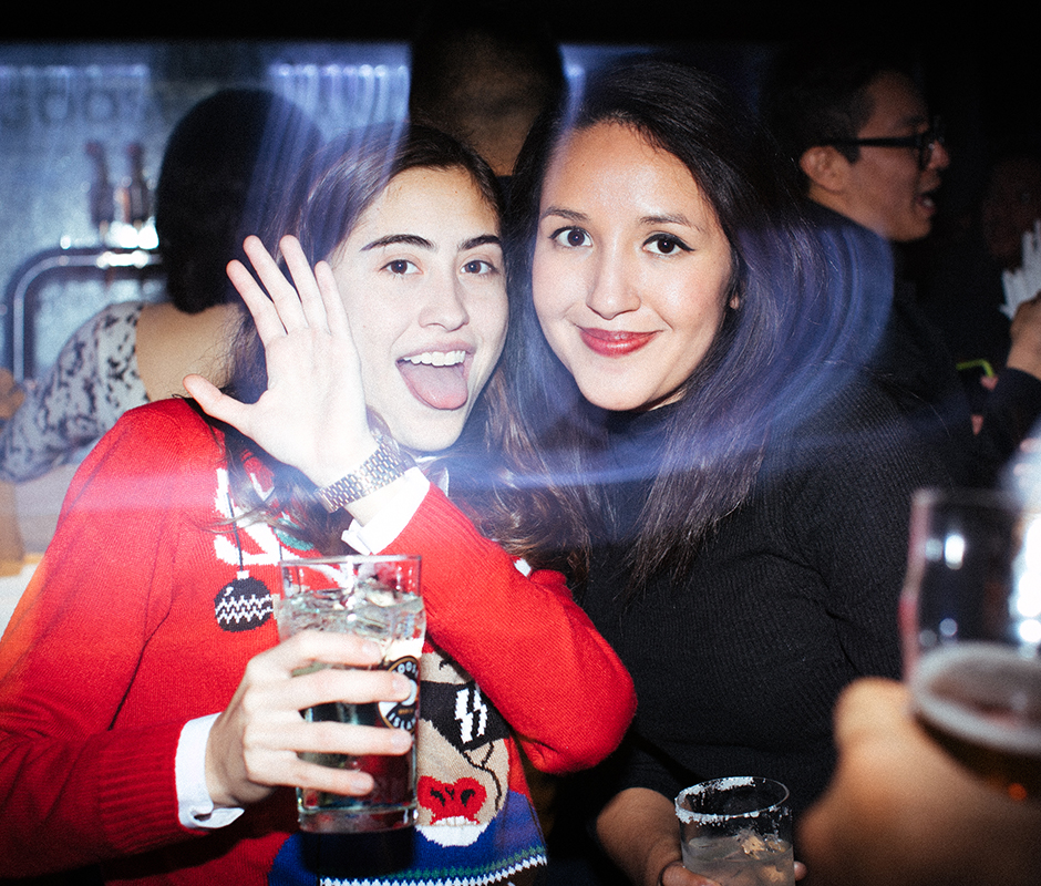 Woman with tongue out posing with friends