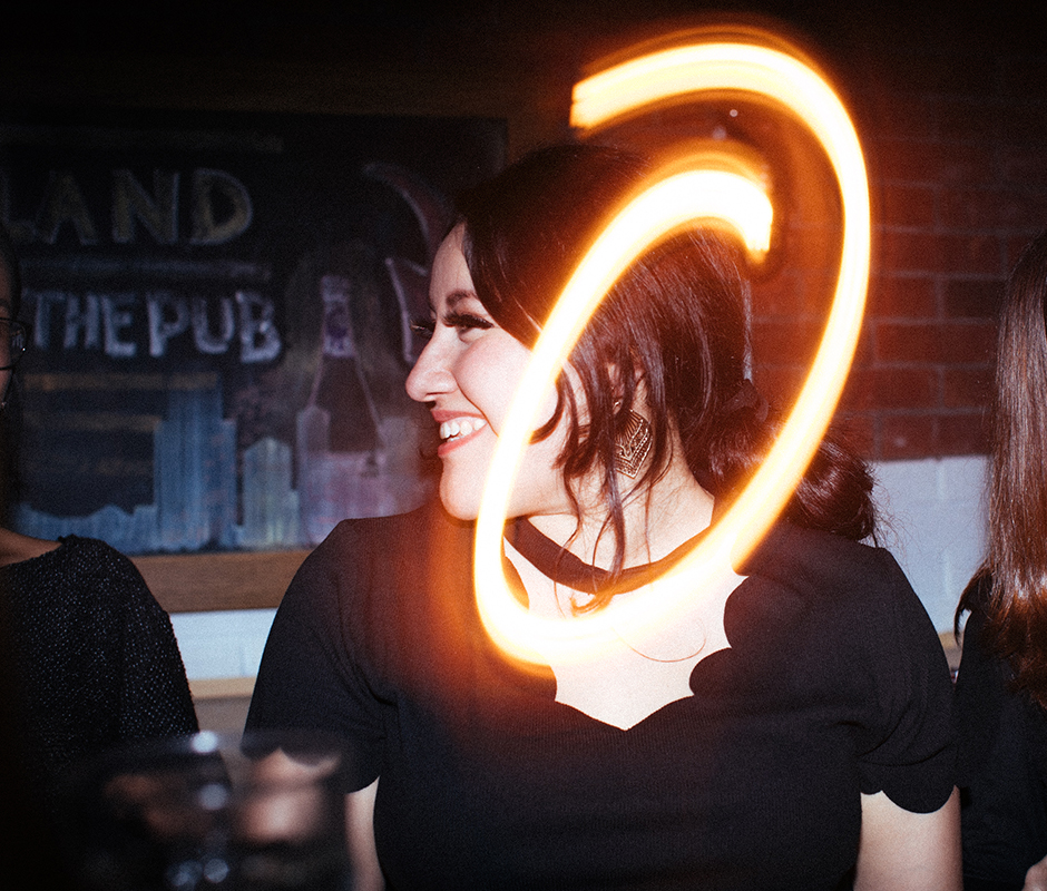 Picture with camera flare of woman at a party