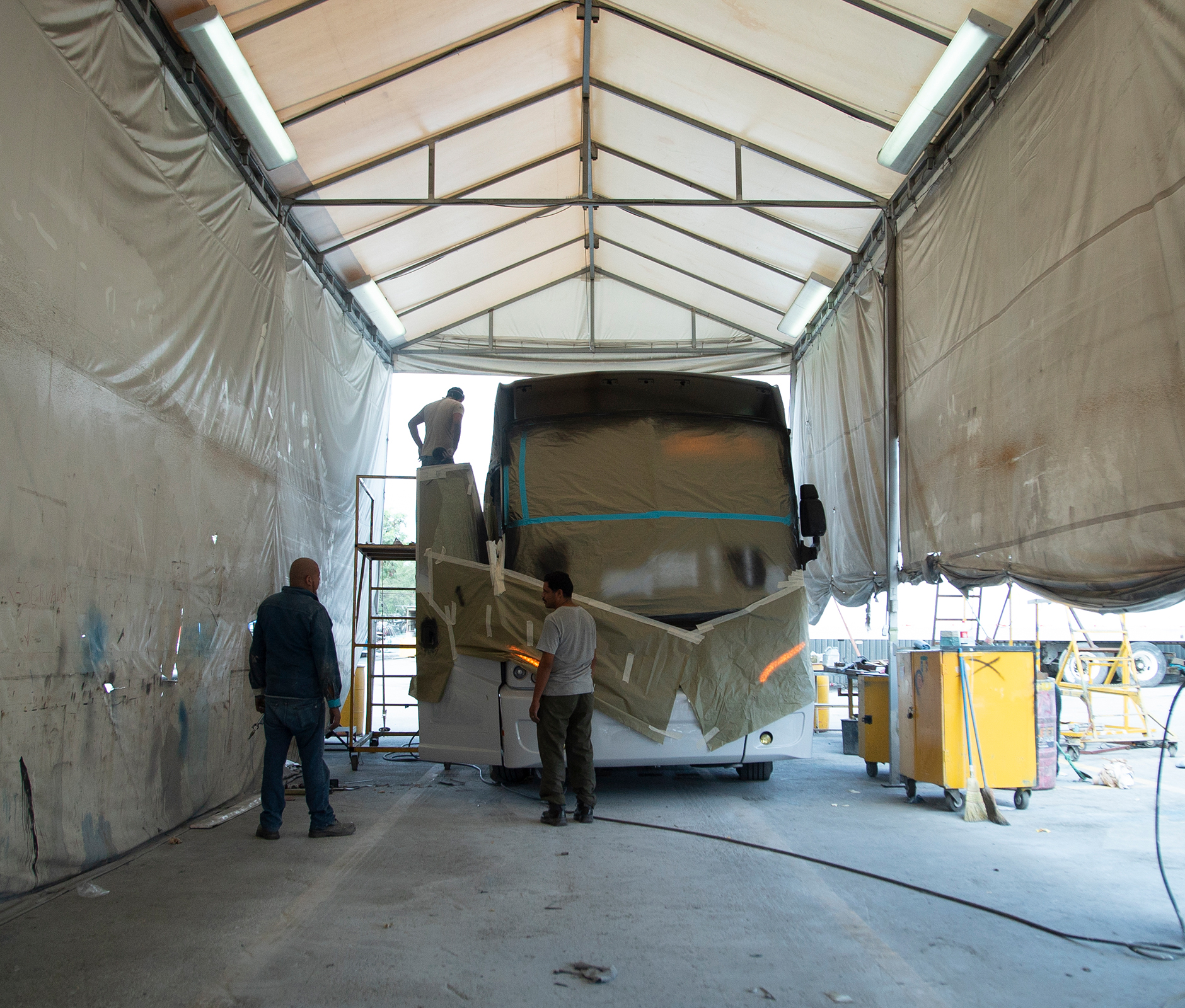 Travel bus being repainted at a workshop