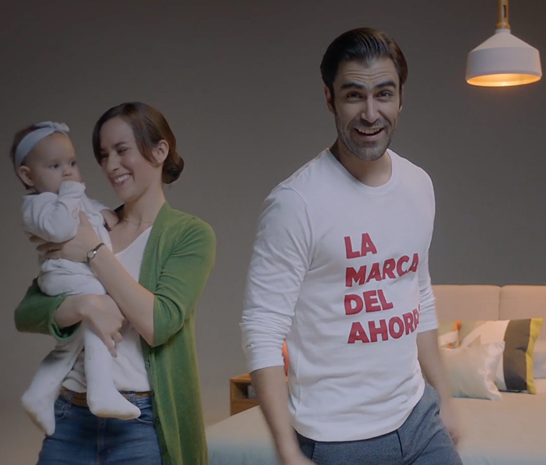 Couple with newborn baby breaking the fourth wall for commercial video