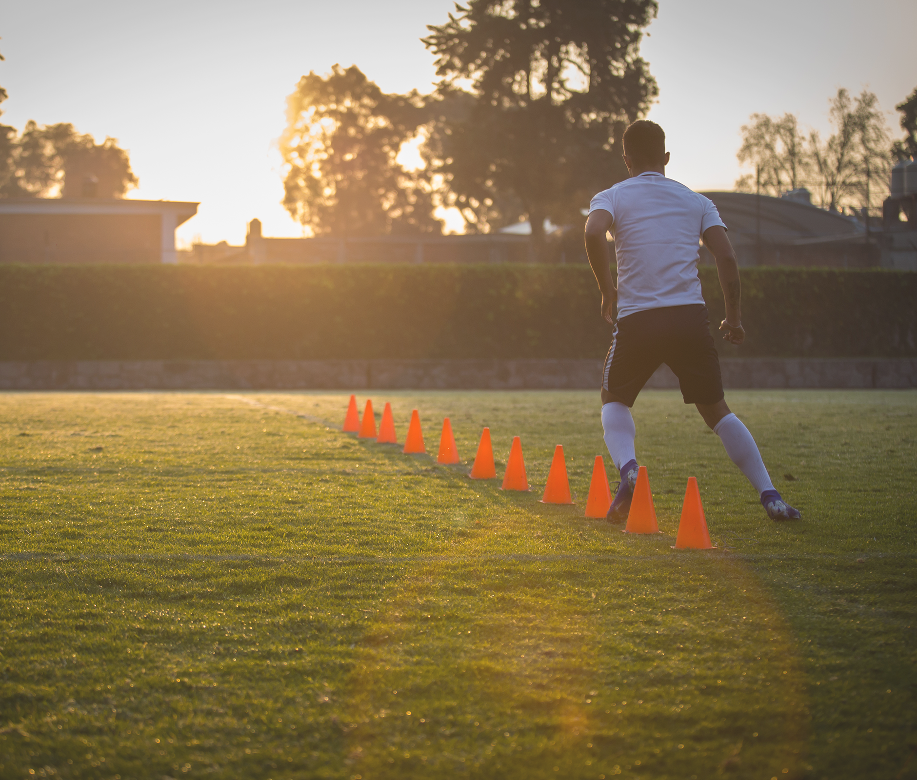 Man warming up doing zic zac at soccer field