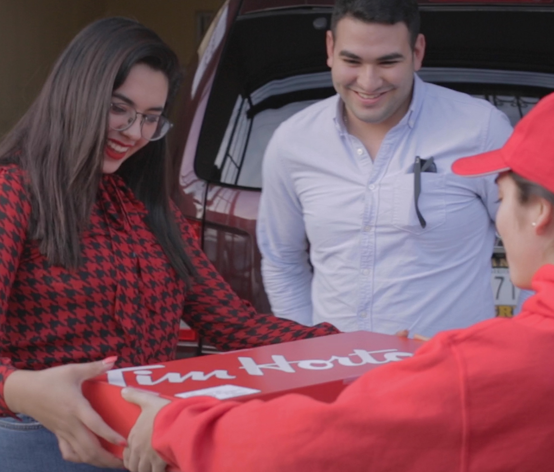 Couple receiving a delivery from Tim Hortons