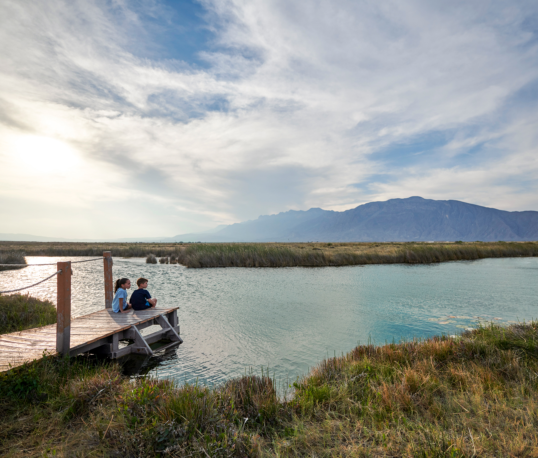 Kids sitting at dock admiring the landscape