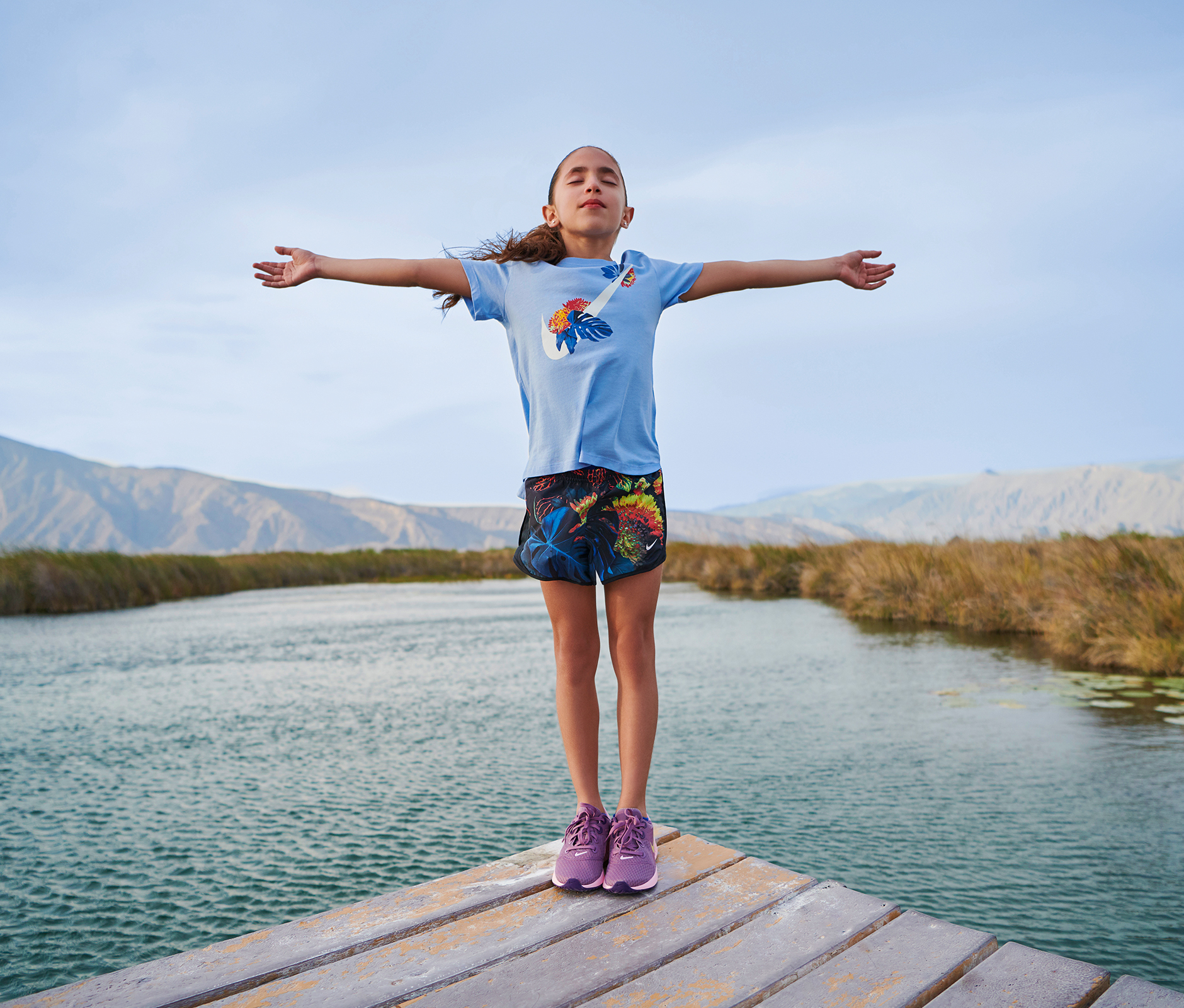 Young girl practising yoga at river side
