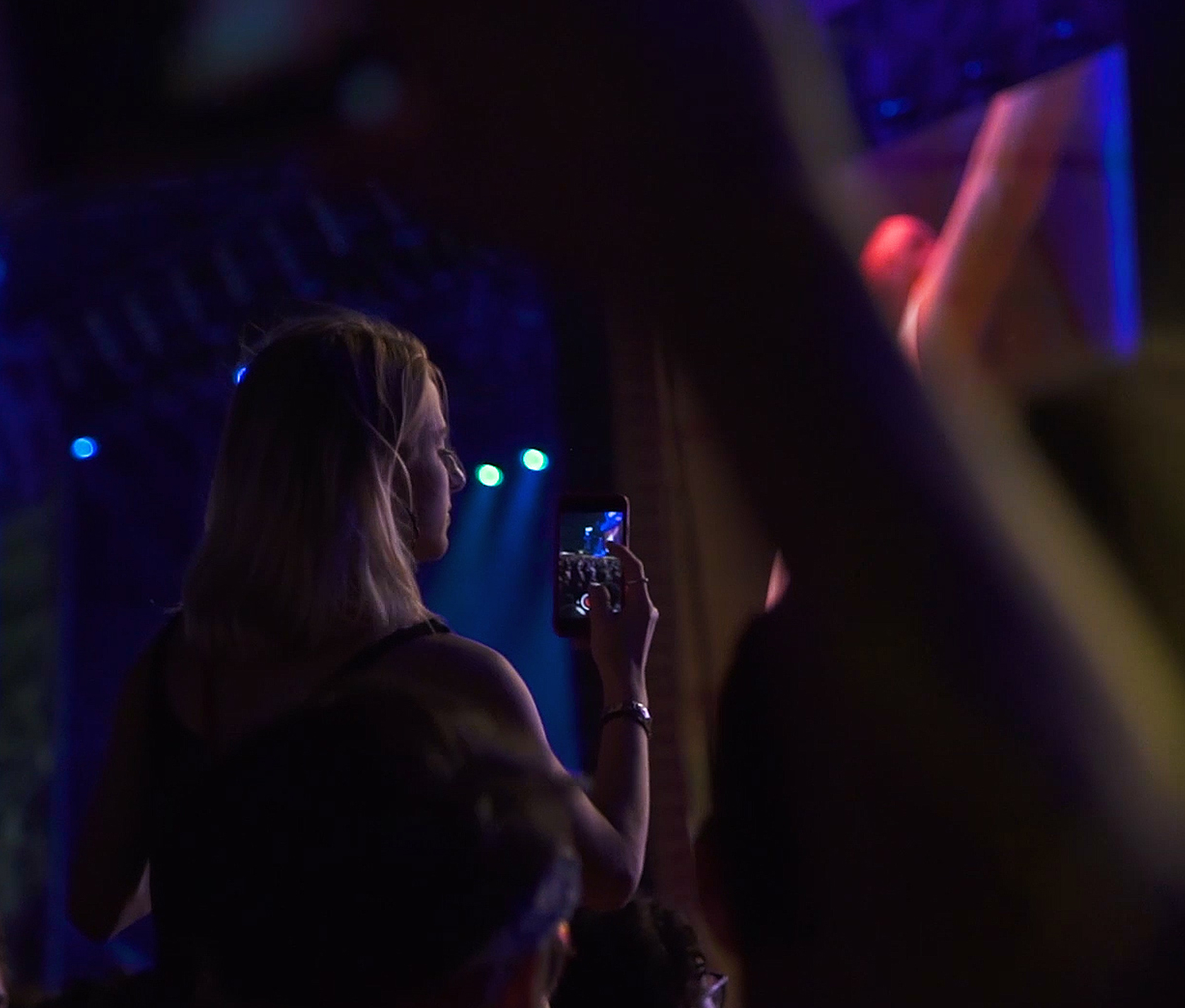 Girl using her phone at a concert