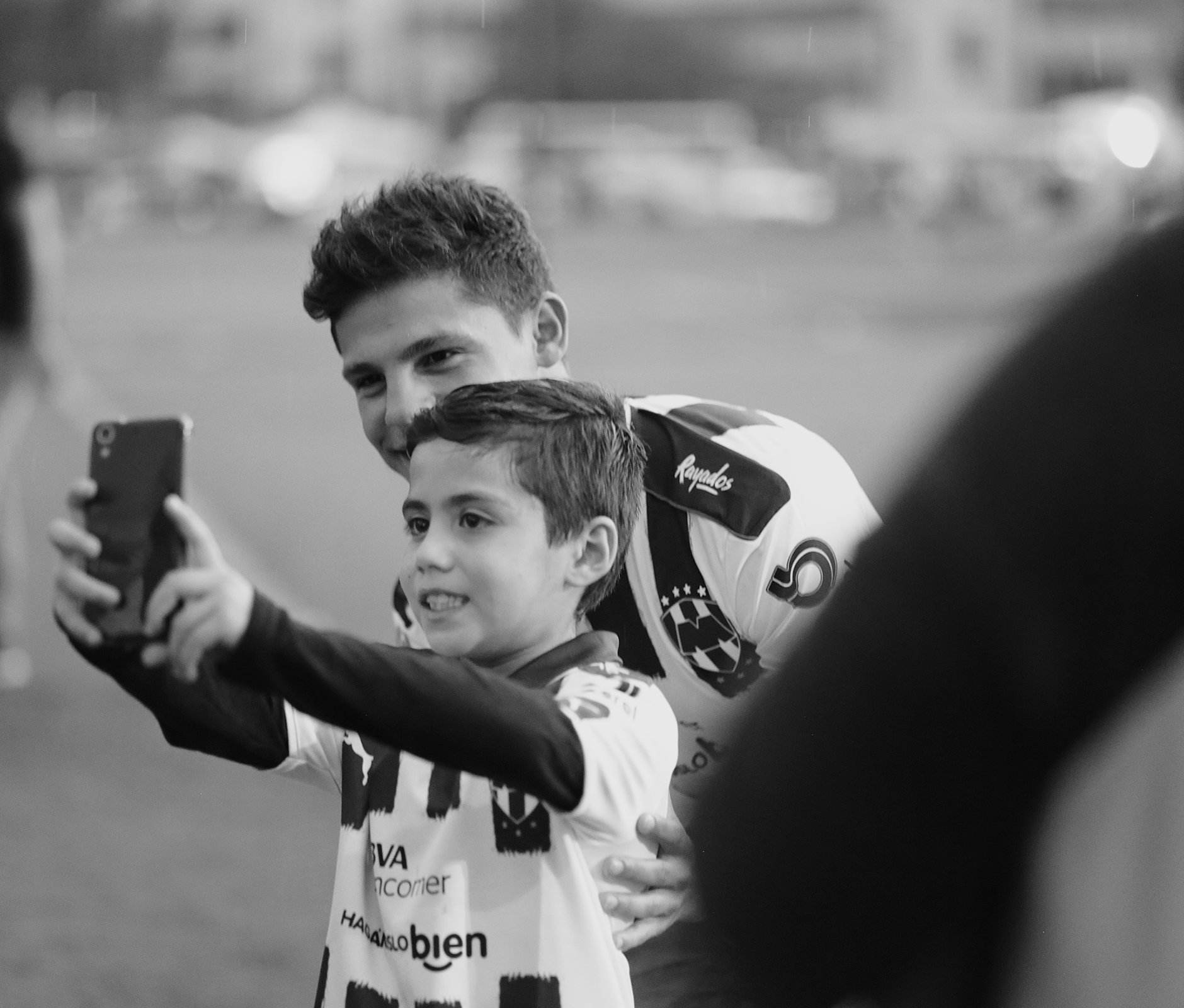 Kid taking a selfie with soccer ball player
