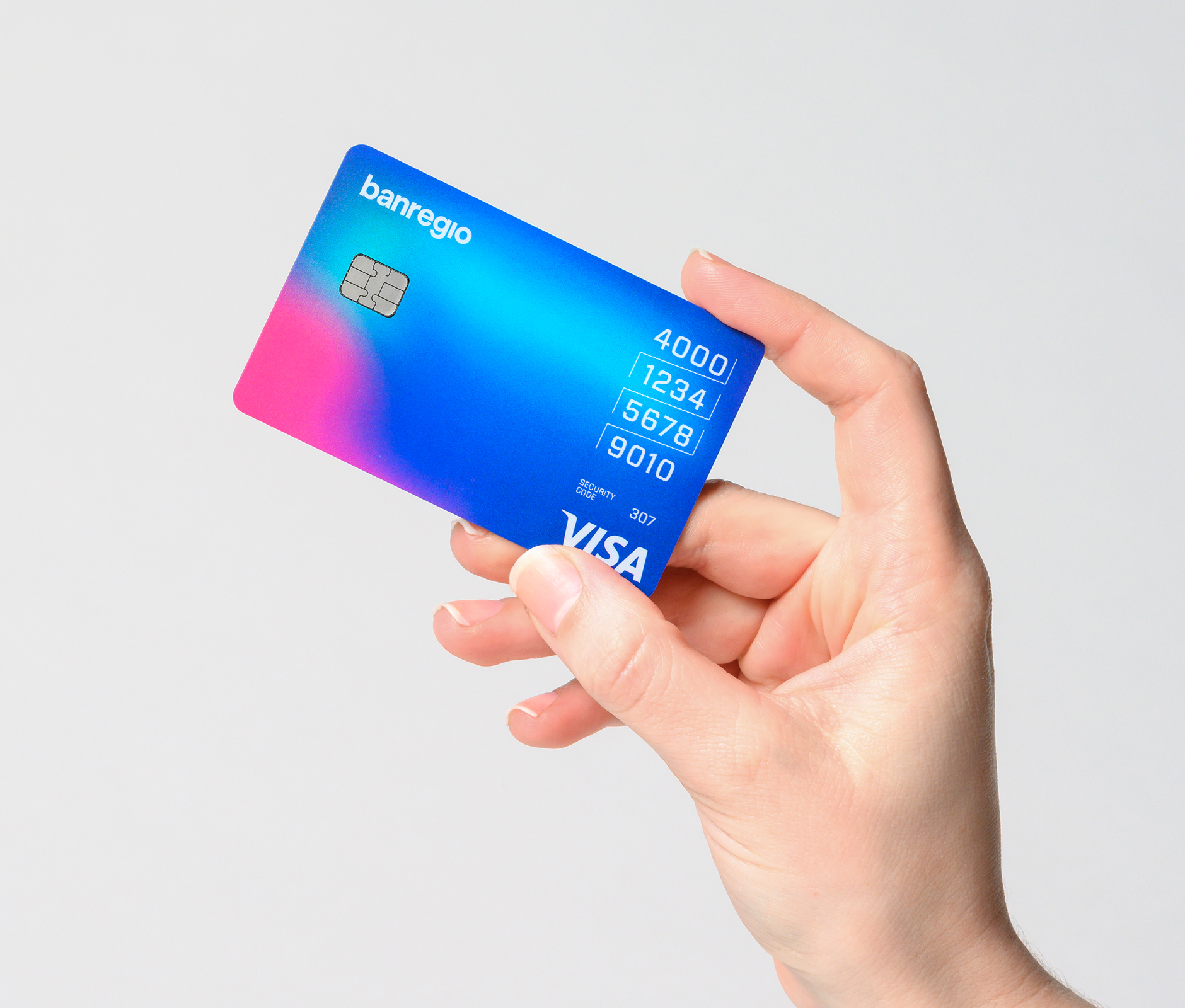 Hand holding credit card with gradient design by Banregio