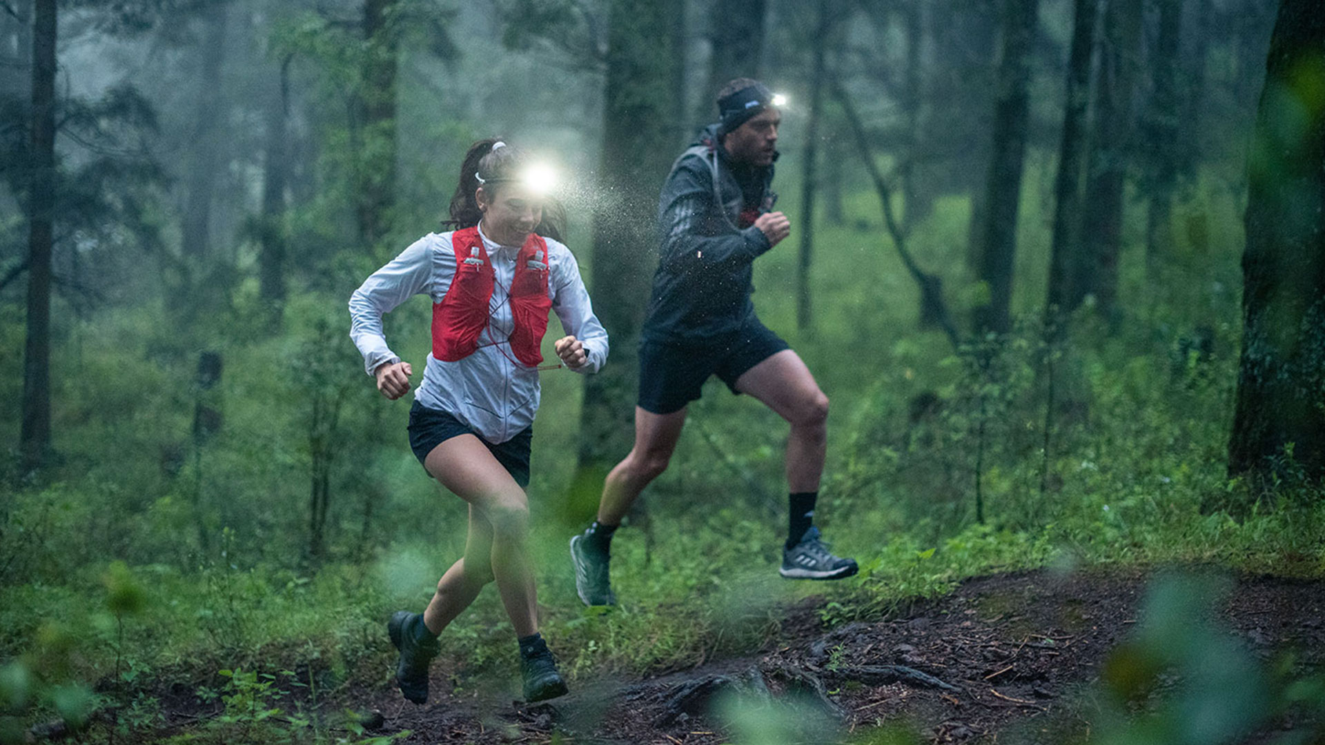 Couple trail running in the forest